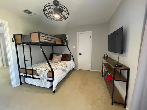 Guest bedroom #4 has queen, trundle bed below and bunk bed up top. 43" Roku Tv (bathroom is shared in hall just outside bedroom door).