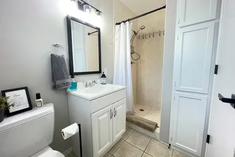 Bathroom #4-Pool/Game Room bathroom and changing room! Perfect for showering off before and after a dip in the pool or hot tub. Note the clips in shower to…
