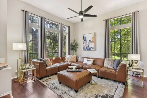 Modern, elegant & comfy front Living Room, generous seating on large leather couch surrounded by views of nature & our heritage Live Oak. So much natural…