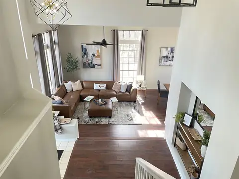 View of entry from stairway down to grand foyer and formal living room