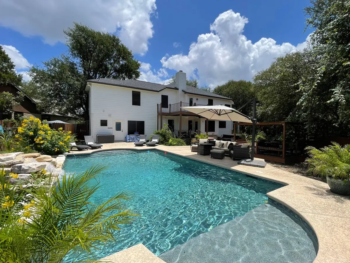 Stunning private backyard set against a luscious very wooded greenbelt with Private Pool, Waterfall, Hot Tub, Firepit, Gazebo with dining areas, Propane…