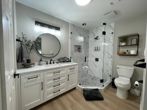 Wow! Modern decor and thoughtfully equipped master bathroom-Custom walk in shower w/glass surround, large vanity with tons of storage!…
